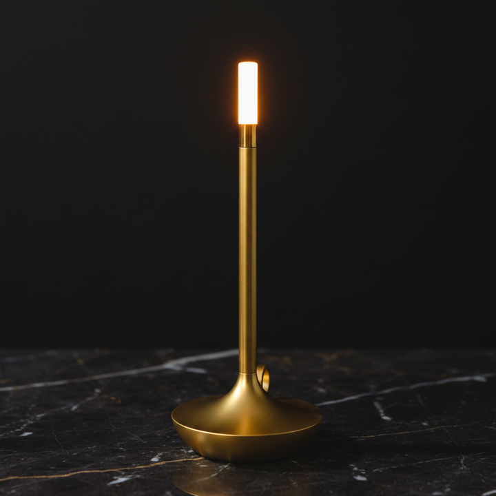 aluminum touch candle lamp gold close-up macro shot dark marble surface warm candlelight glow